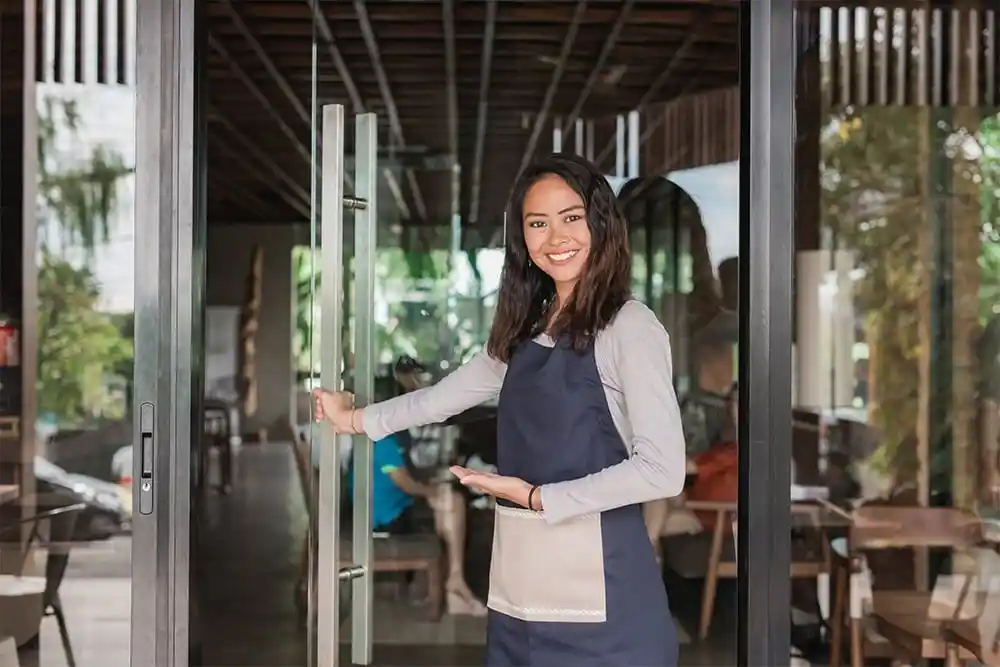 restaurant staff welcoming customers at entrance